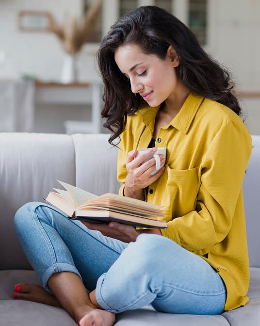 Woman with cup and book